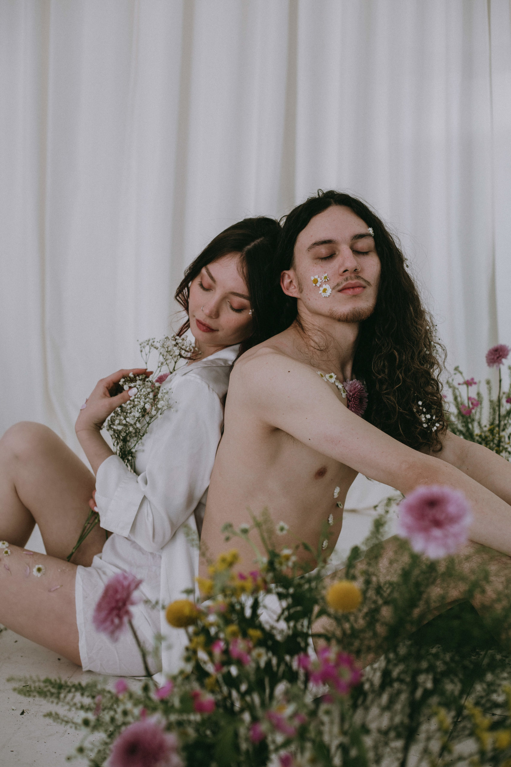 Couple in albuquerque photography studio with flower accents.