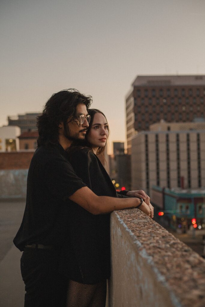 Couple watching the sunset together in Albuquerque New Mexico. 