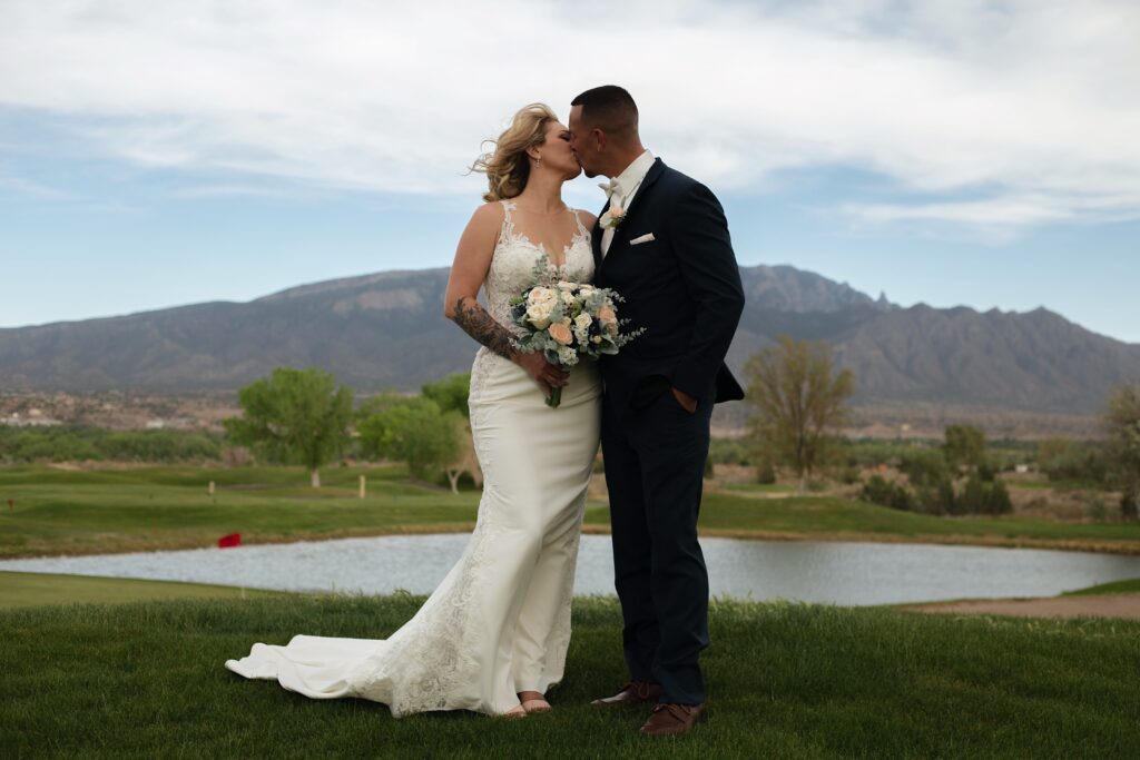 Bride and groom kiss at wedding in albuquerque new mexico.